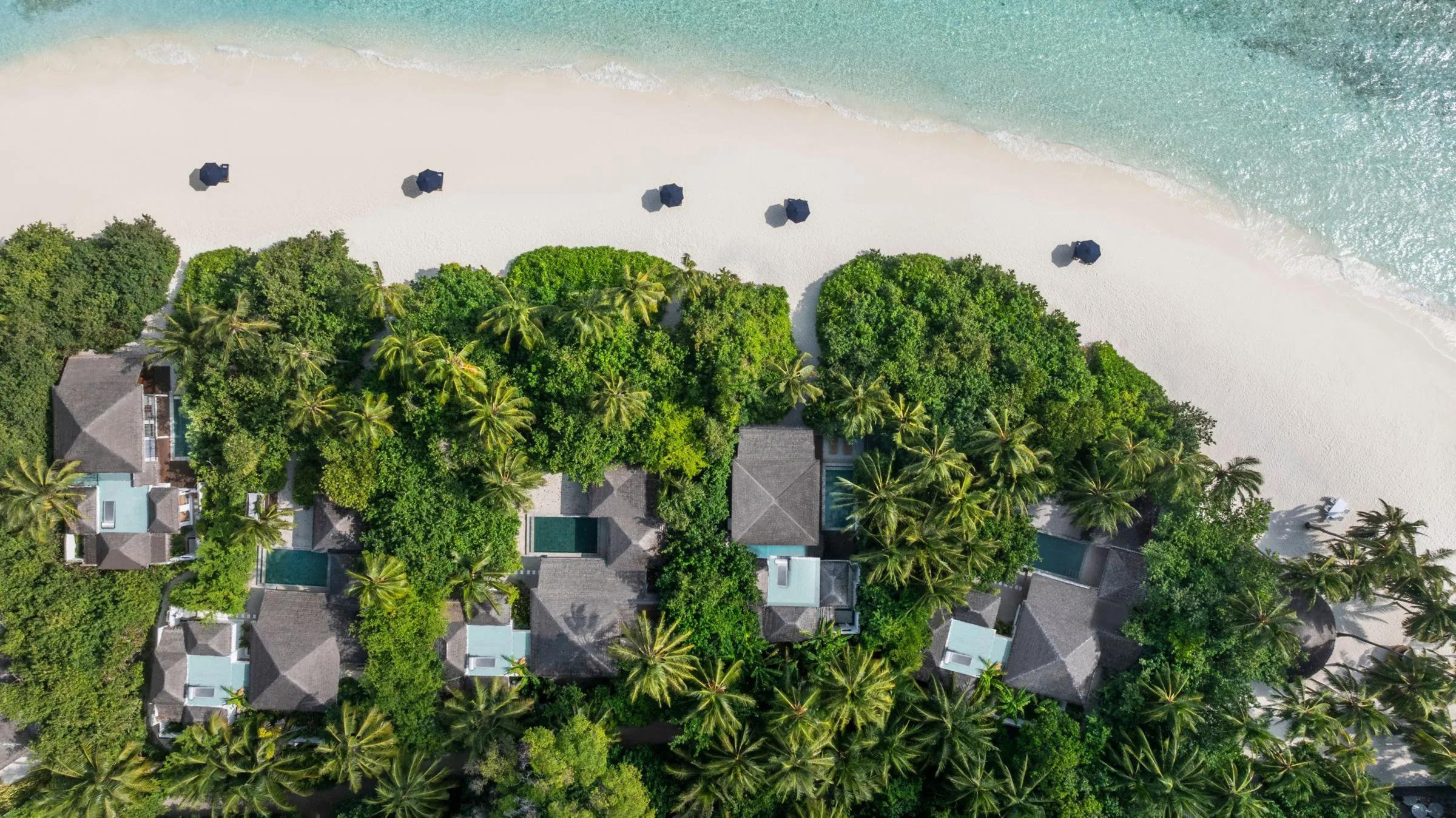 Aerial view of Halcyon's villas stepping out from the beach across the lagoon