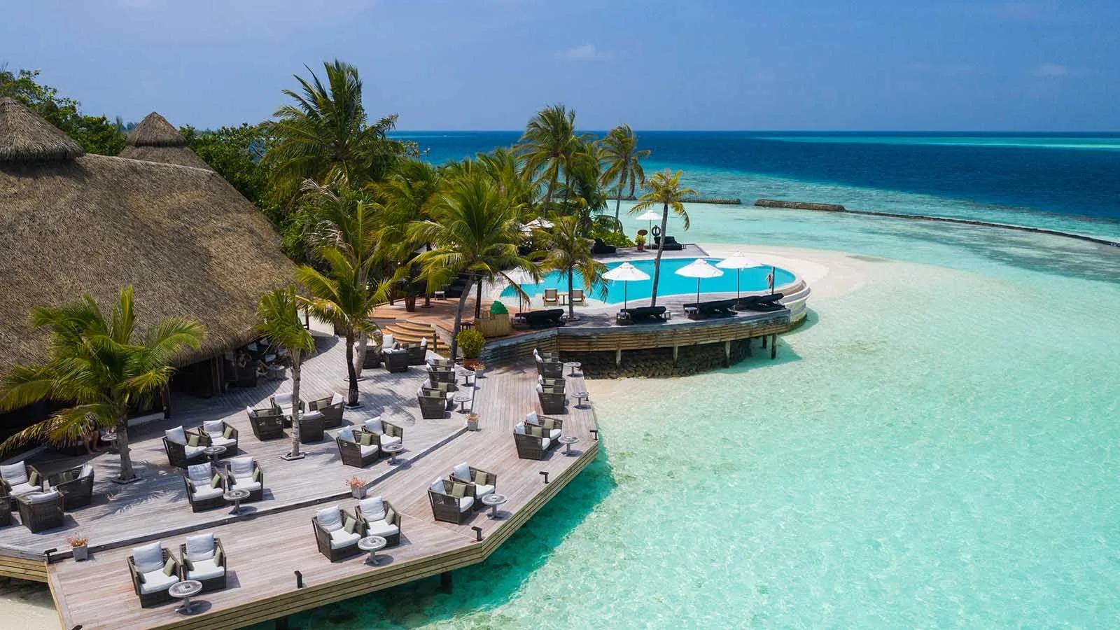 Aerial view of the outdoor lounge deck and freshwater infinity pool around Kandu Bar, overlooking the lagoon