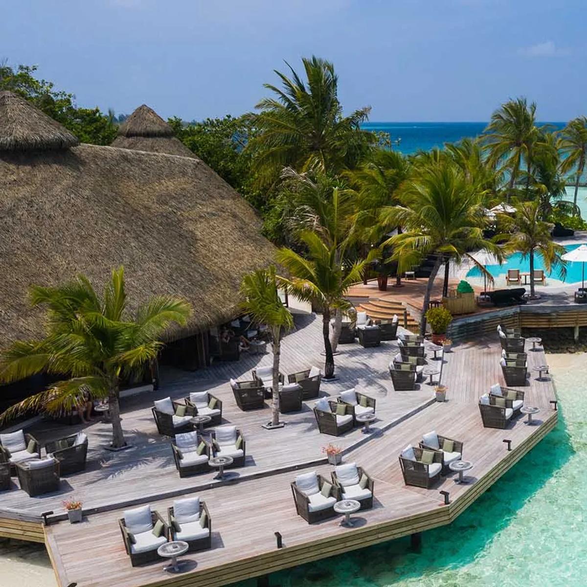Aerial view of the outdoor lounge deck and freshwater infinity pool around Kandu Bar, overlooking the lagoon