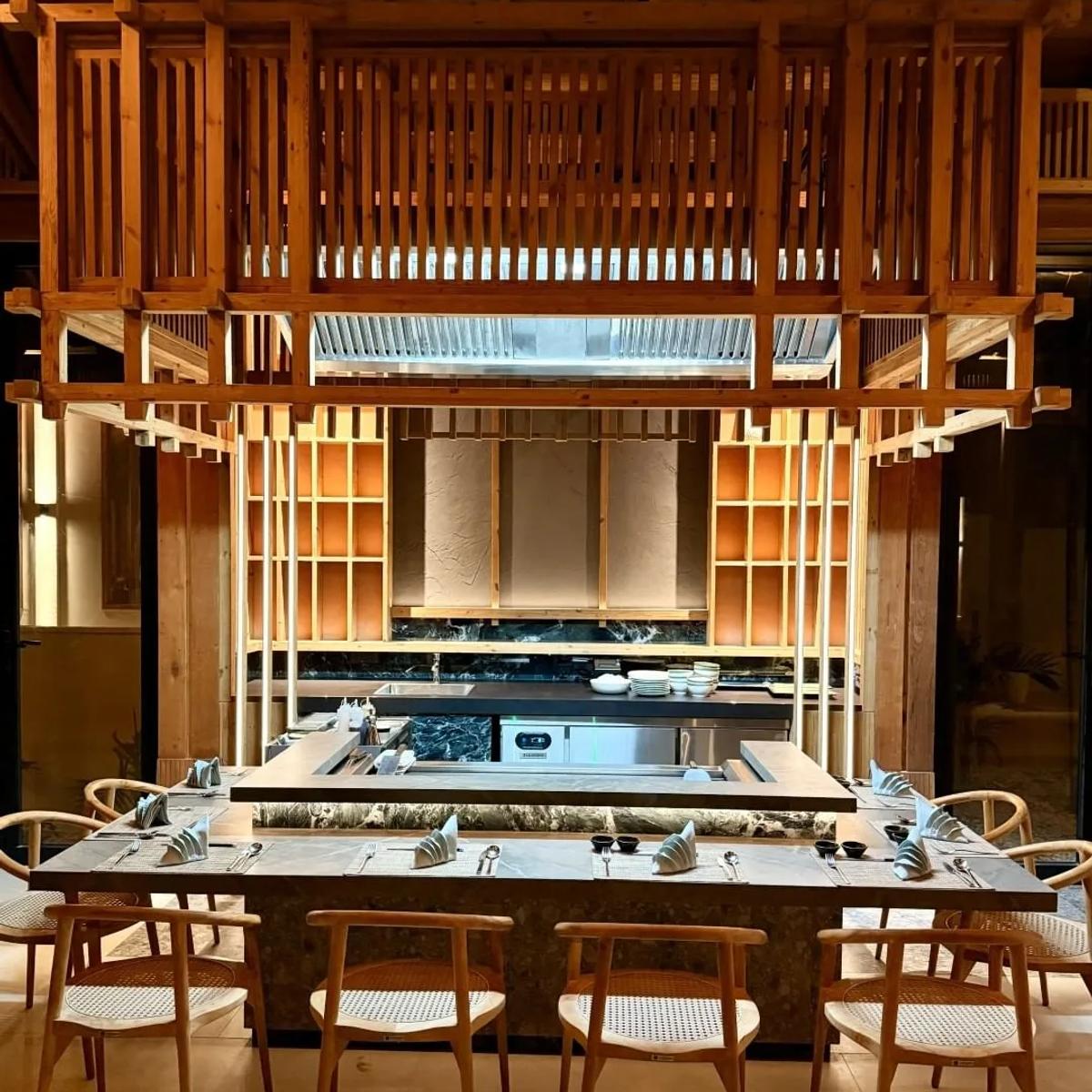 Ikigai's teppanyaki counter and open grill, set beneath a timber-slat mezzanine