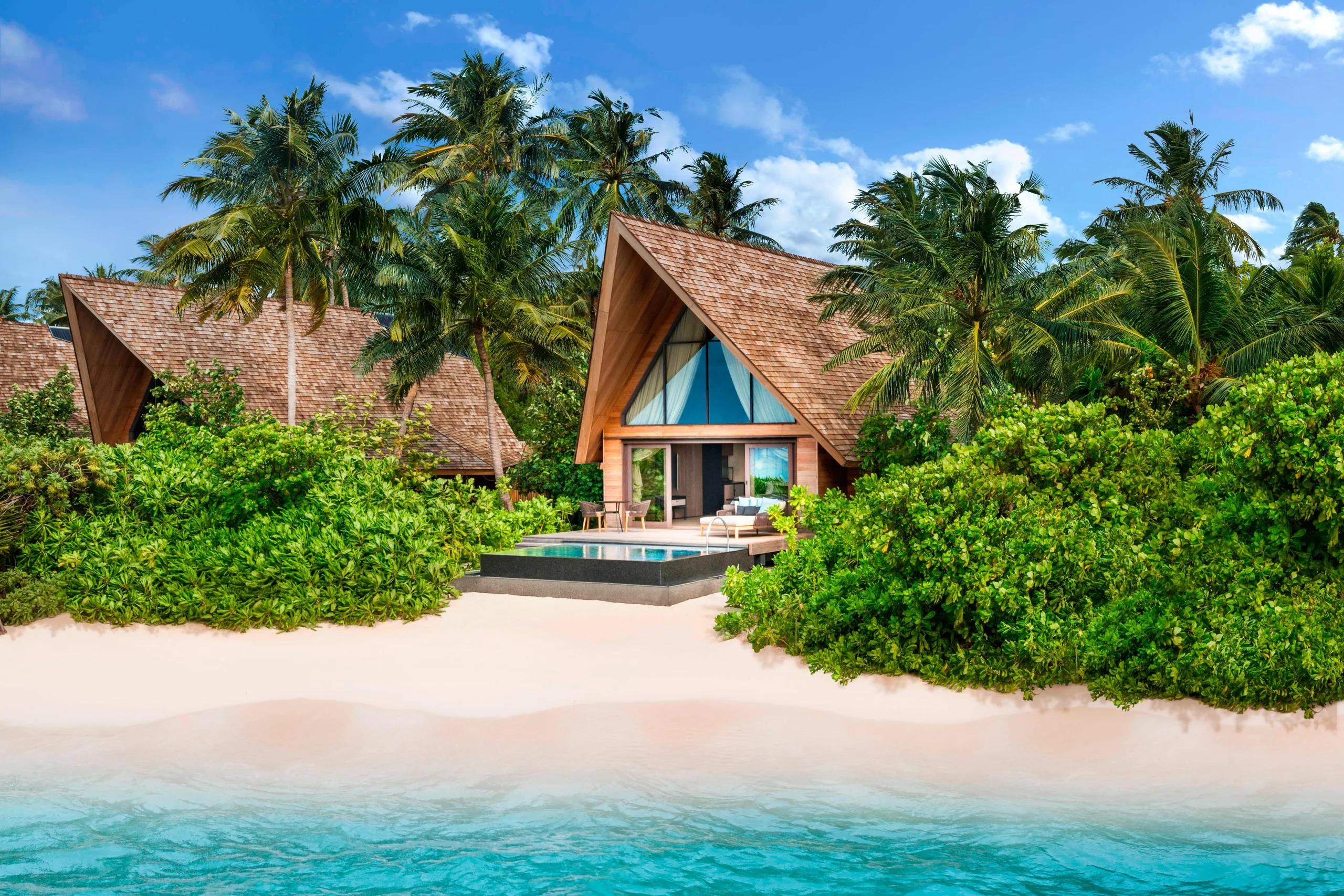 The exterior of a Beach Villa with Pool, set directly on the white sand