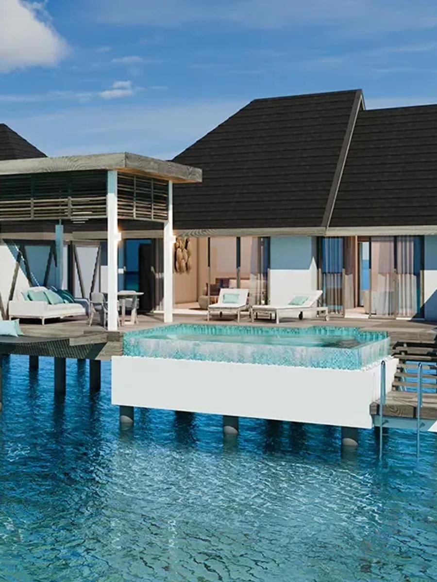 A row of Meyyafushi's 2-Bedroom Water Pool Villas with Slide, overwater decks and pools reaching into the lagoon
