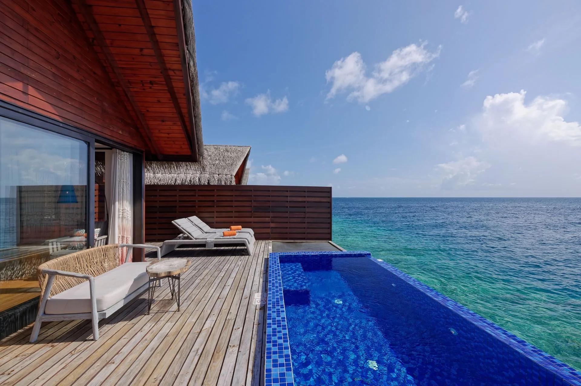 The deck of a Reef Pool Water Villa in daylight, set over the house reef