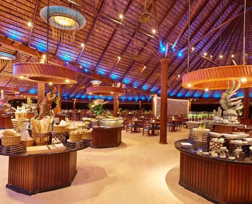 Koamas Restaurant's buffet counters under a thatched roof strung with round pendant lights