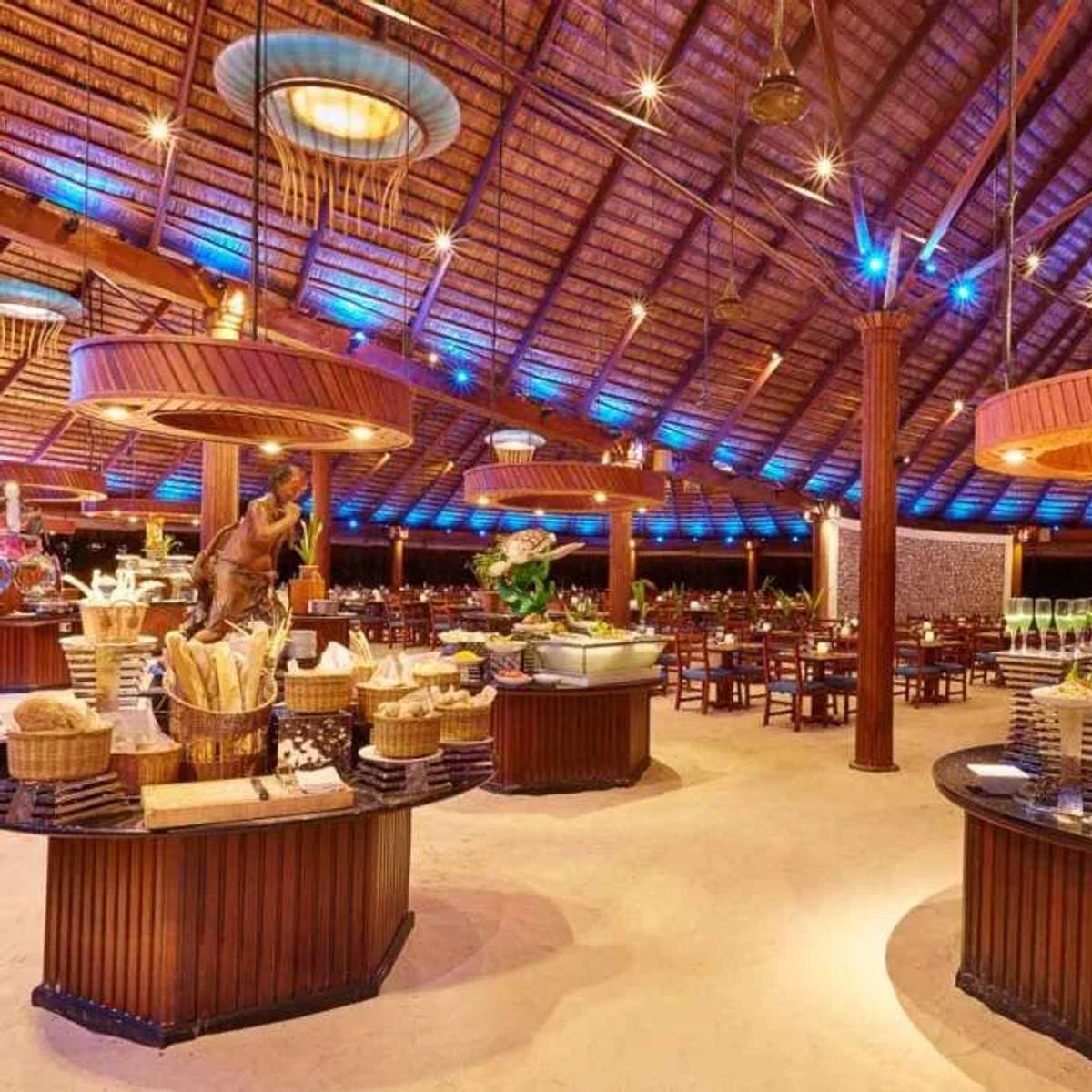 Koamas Restaurant's buffet counters under a thatched roof strung with round pendant lights