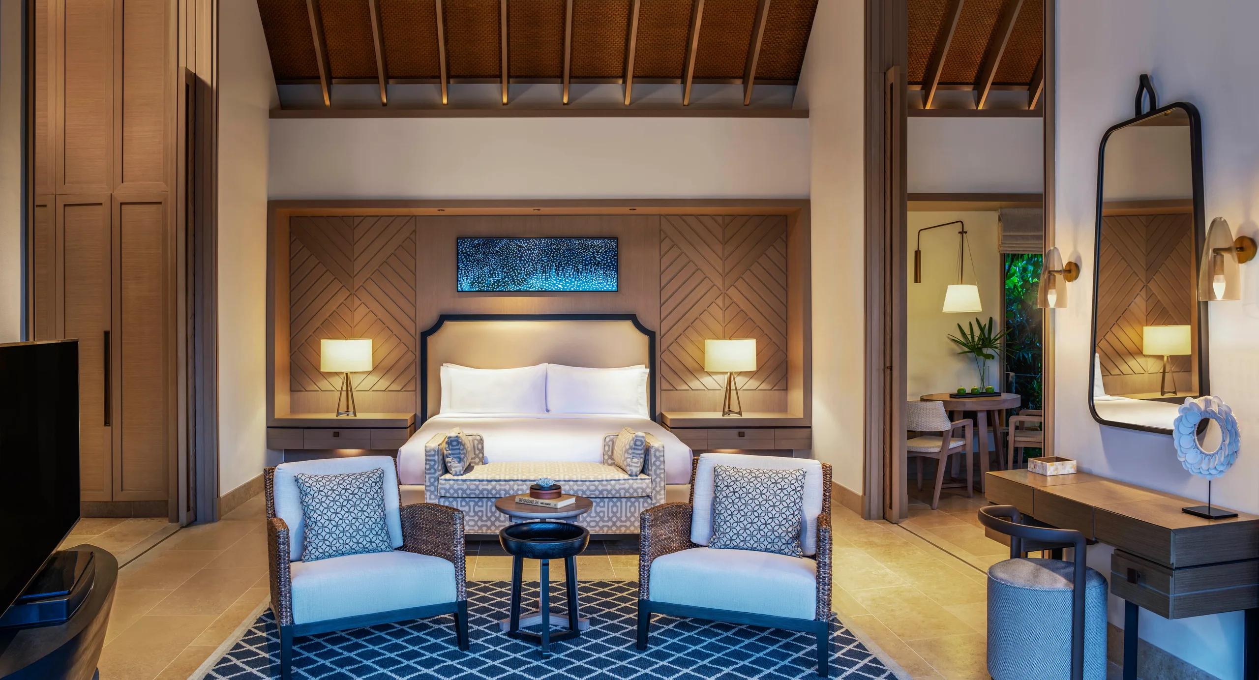 The bedroom and living area of a Grand Beach Villa at Waldorf Astoria Maldives Ithaafushi
