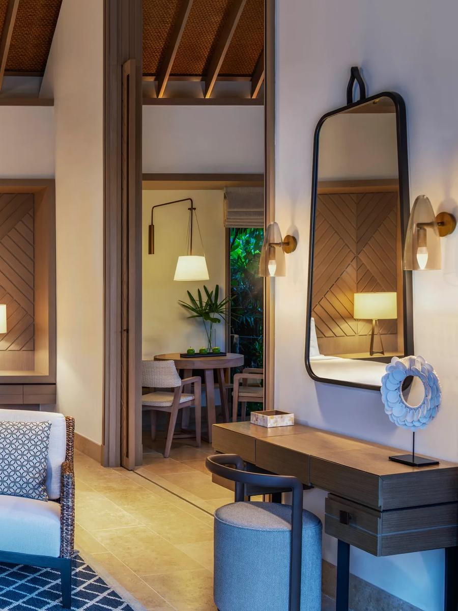 The bedroom and living area of a Grand Beach Villa at Waldorf Astoria Maldives Ithaafushi