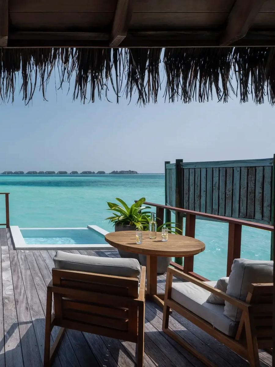 The deck of a Sunrise Water Villa over open lagoon water at Conrad Maldives Rangali