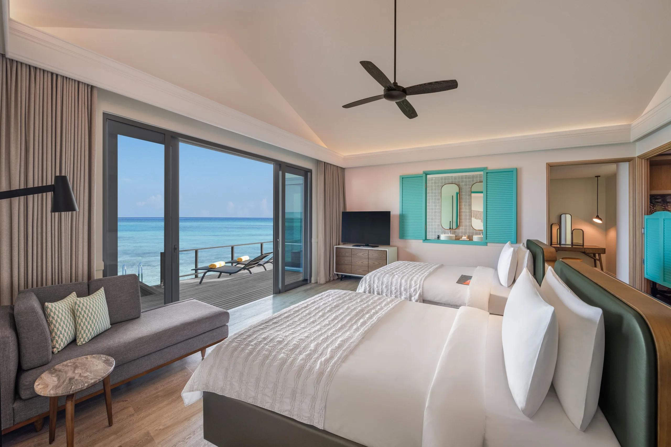 The Two Bedroom Overwater Pool Villa perched over crystal-clear water