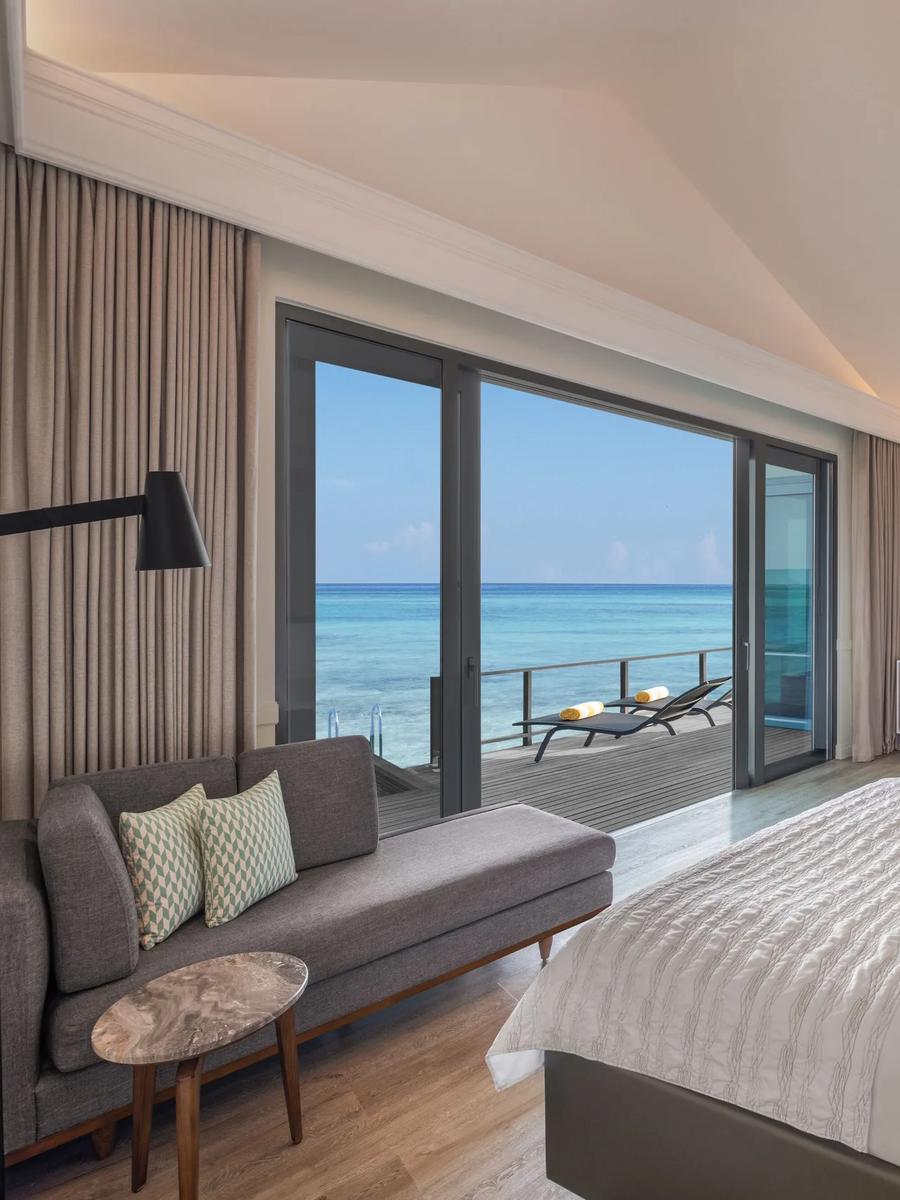 The Two Bedroom Overwater Pool Villa perched over crystal-clear water