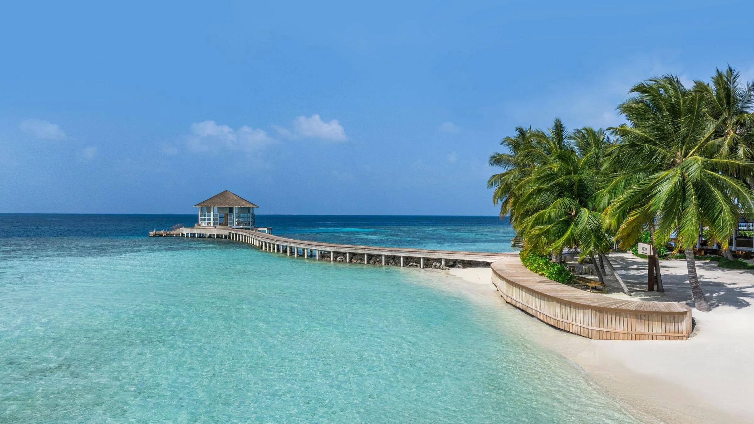 A seaplane on approach to Halcyon's jetty, the resort's official 'Seaplane Arrival' image