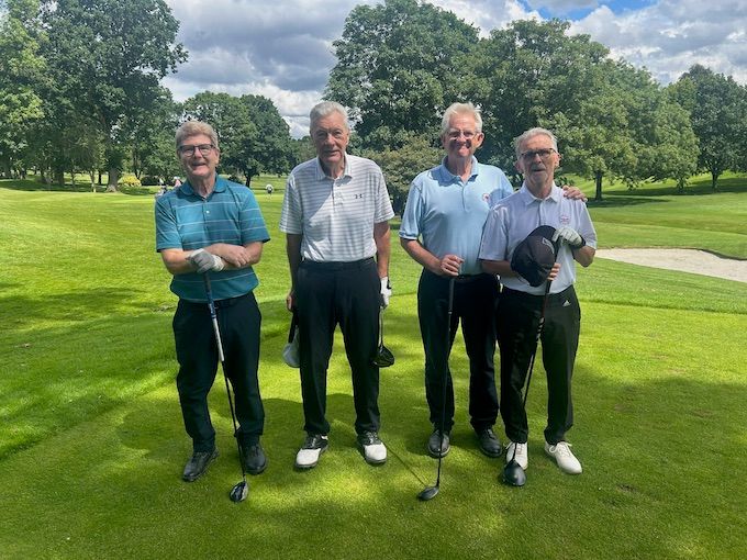 A four-ball on the tee under big skies