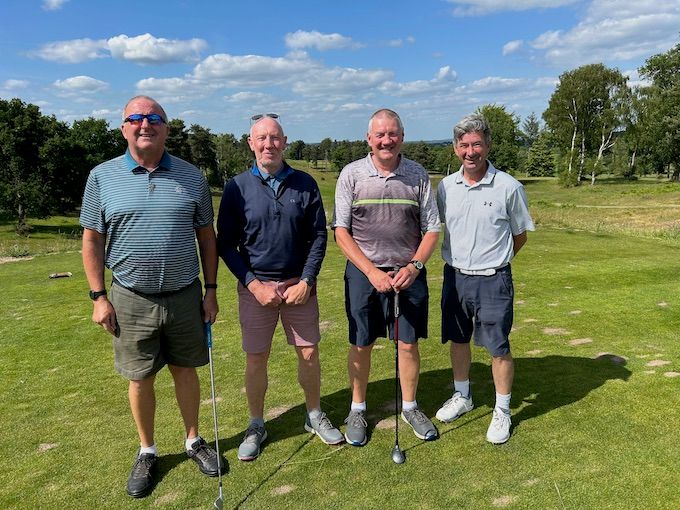 A four-ball on the tee with the heathland behind