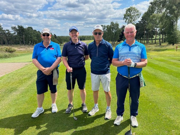 A group on the tee beside the silver birches