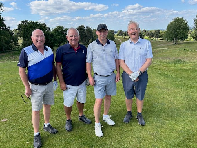 Members on the tee with the course rolling away behind