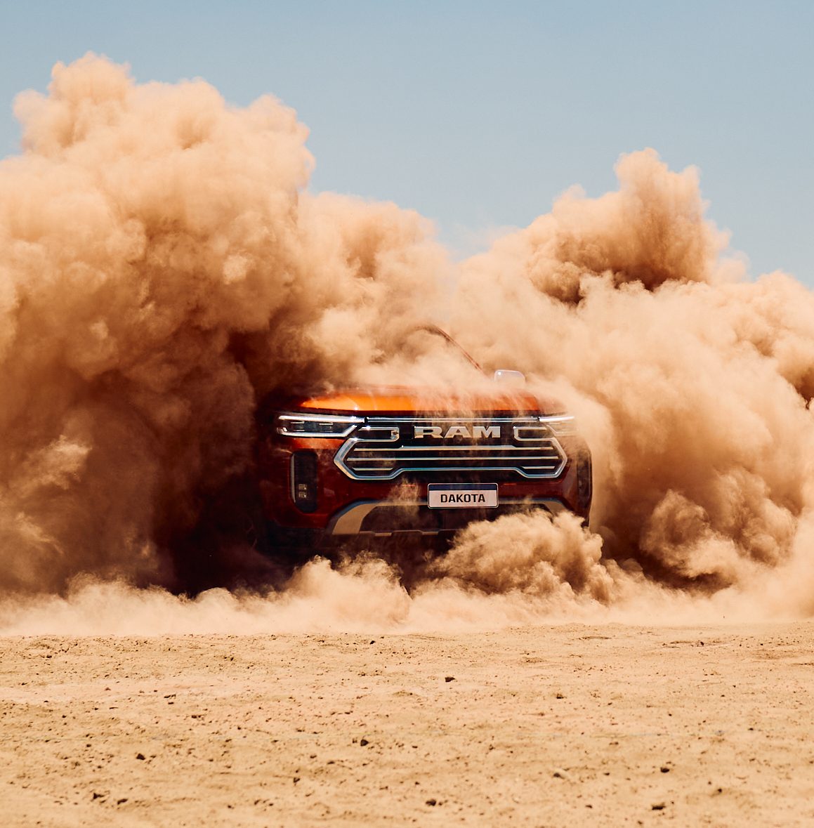 Front of a RAM Dakota swallowed by a cloud of kicked-up dust