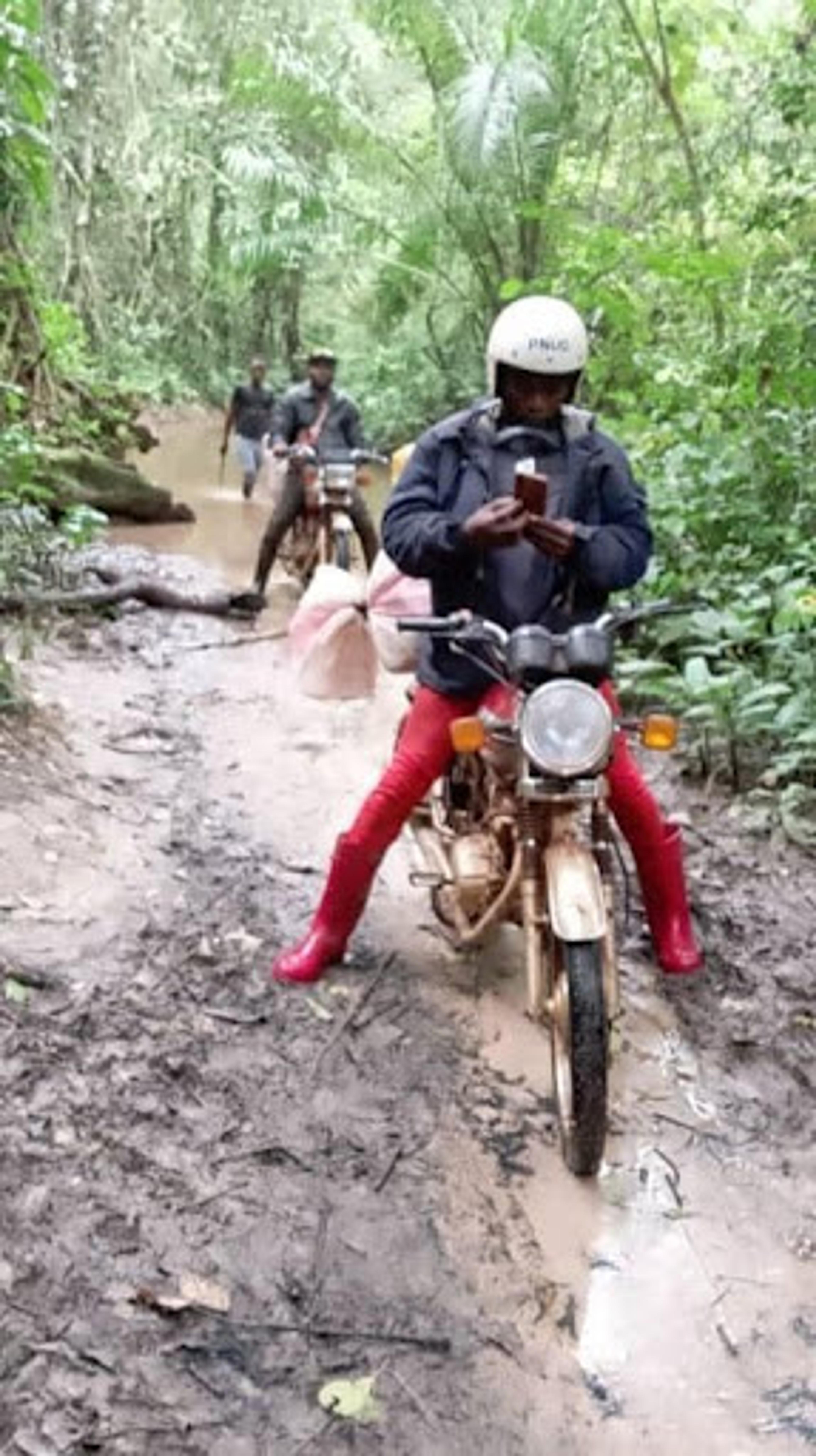 Data collector navigating a muddy road on a bike