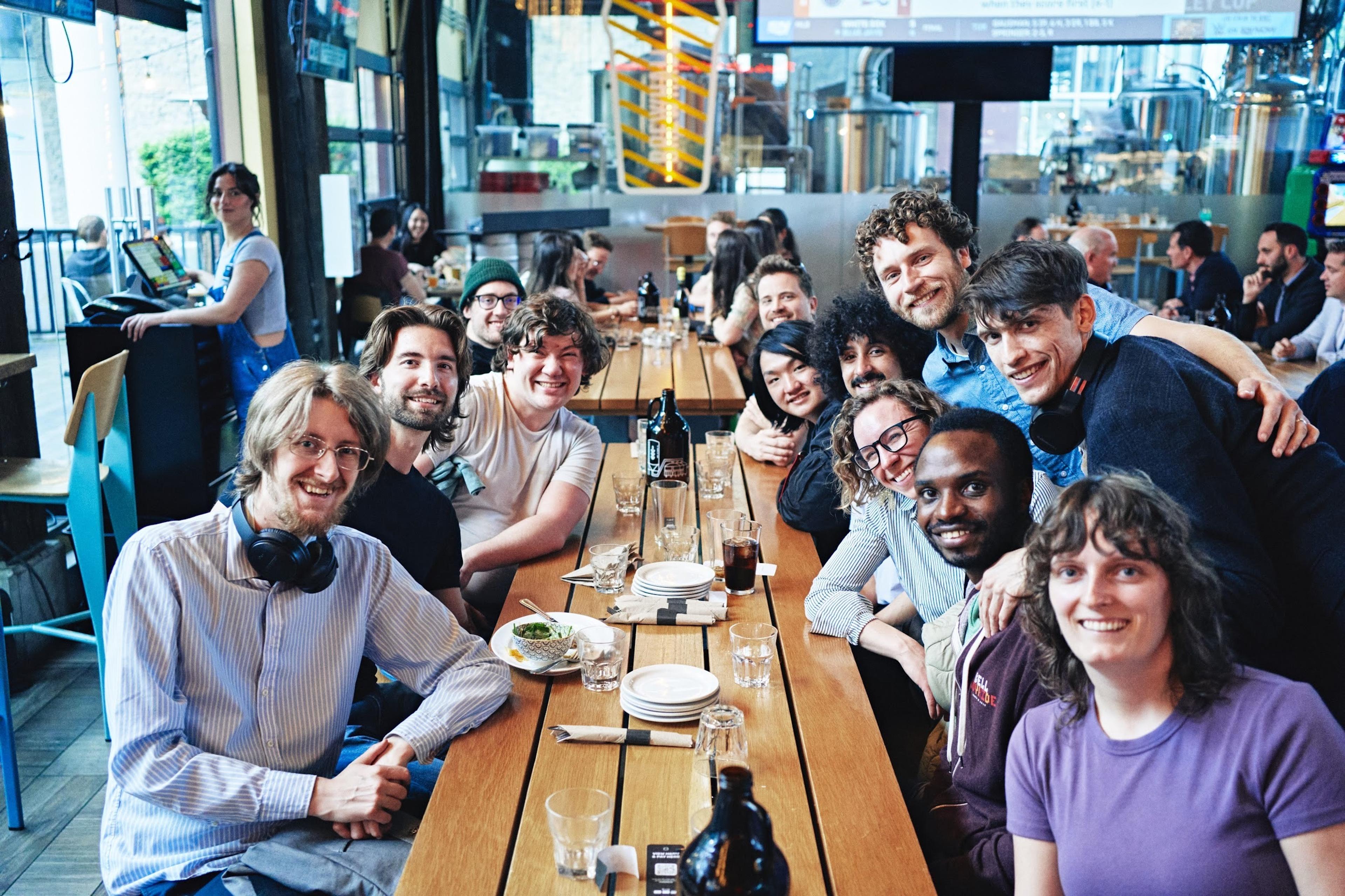 a group of people at a cafe smiling together