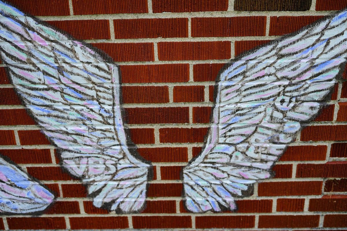 A smaller pair of wings painted low, near ground level