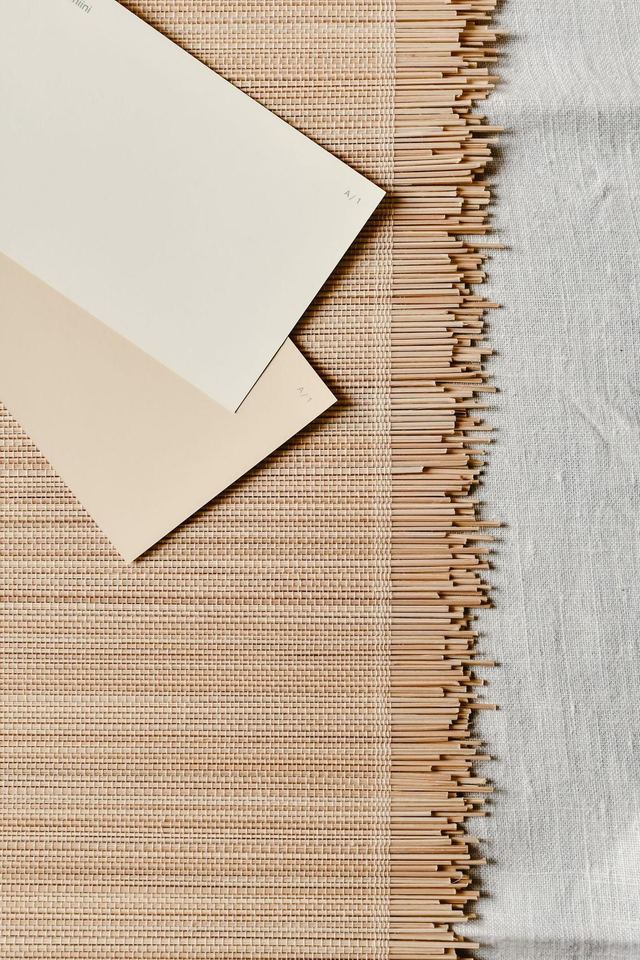 Flat-lay of woven cane, washed linen and paint swatches