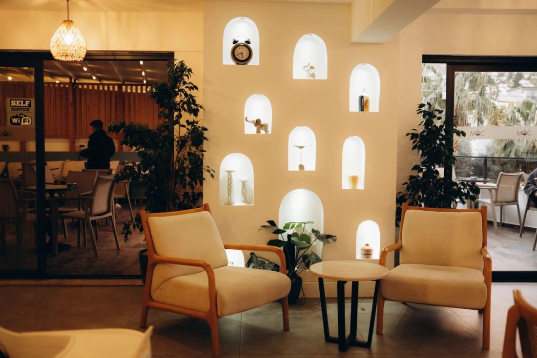 Café lounge with an arched-niche feature wall and tan leather armchairs