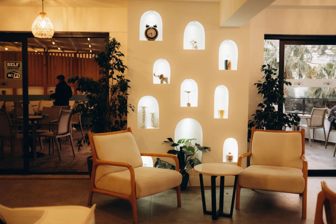 Café lounge with an arched-niche feature wall and tan leather armchairs