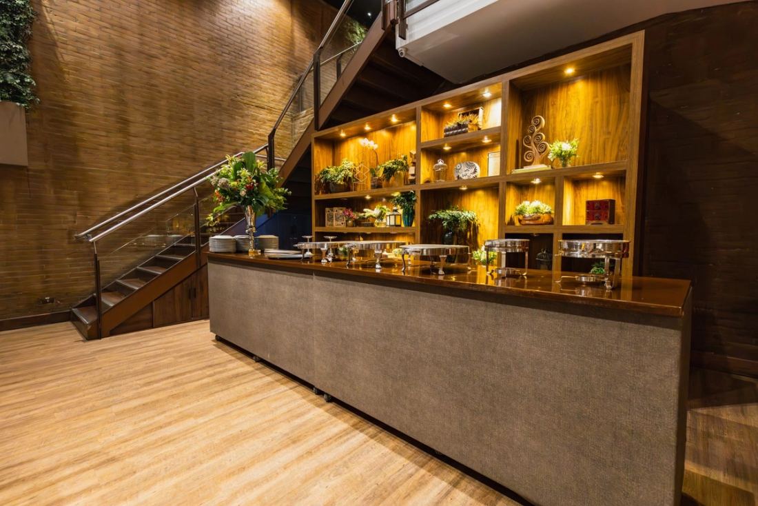 Restaurant bar with a back-lit brass and timber bottle wall
