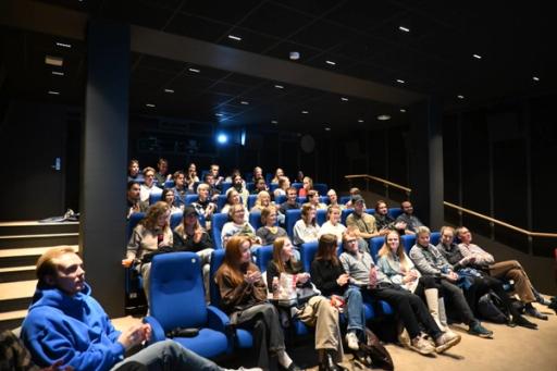En fullsatt sal gleder seg til film.