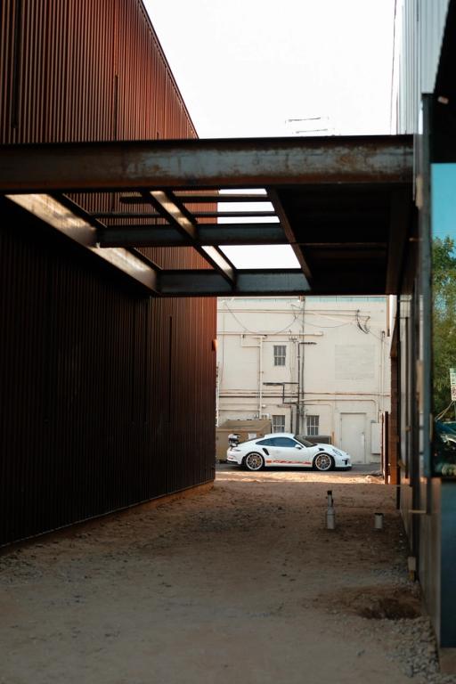 White GT3RS with orange stripes in an industrial environment 