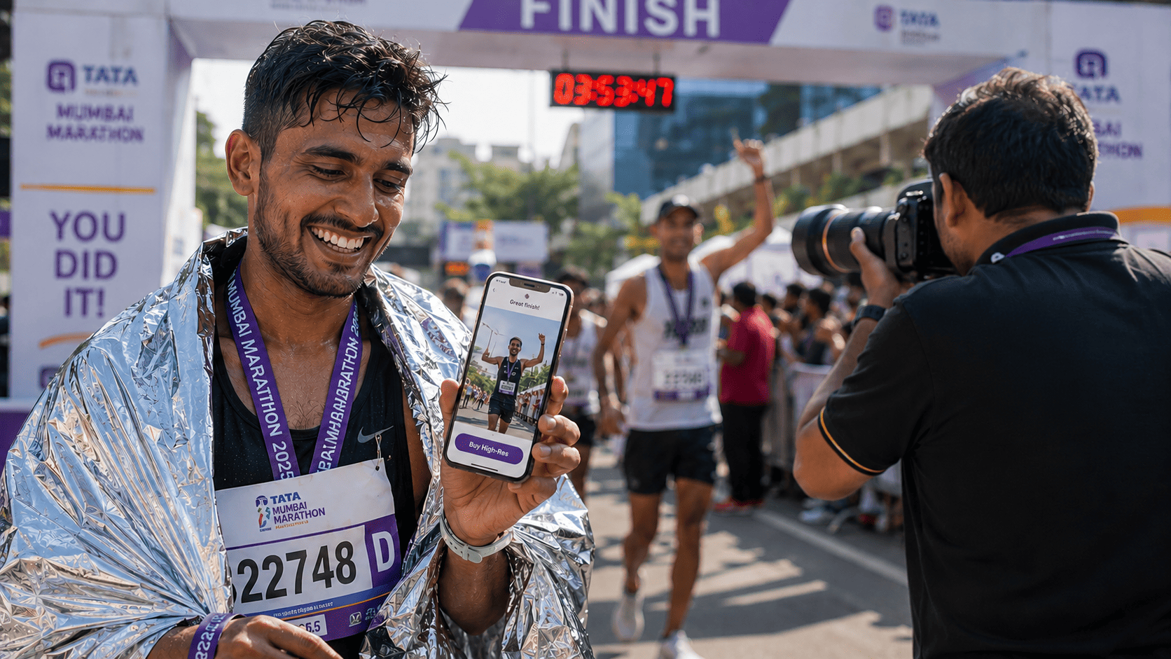 Euphoric Indian marathon runner smiles while viewing his real-time race photos on a smartphone at the finish line