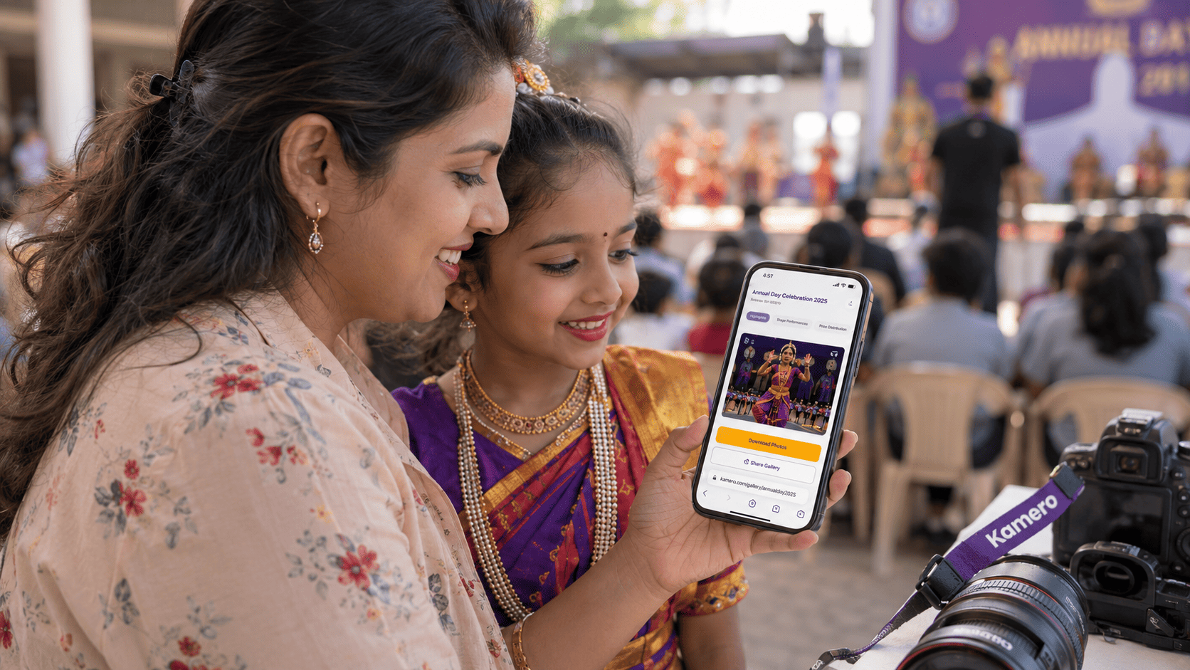 Indian mother and daughter viewing real-time school Annual Day photos on a smartphone via Kameroâs AI event gallery.