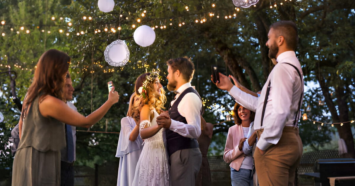 Family members taking pictures of Bride and Groom.