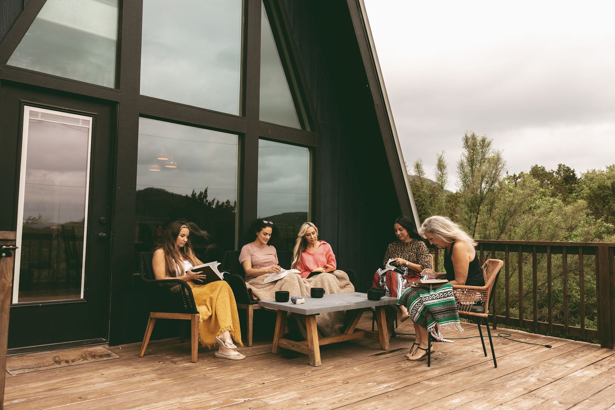 Women reading on the porch of the Aframe at The Inn Between
