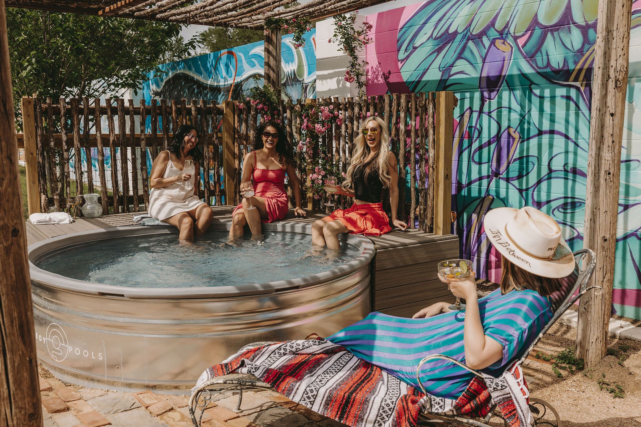 Women sitting in cowboy pool at the inn between in Concan, Texas