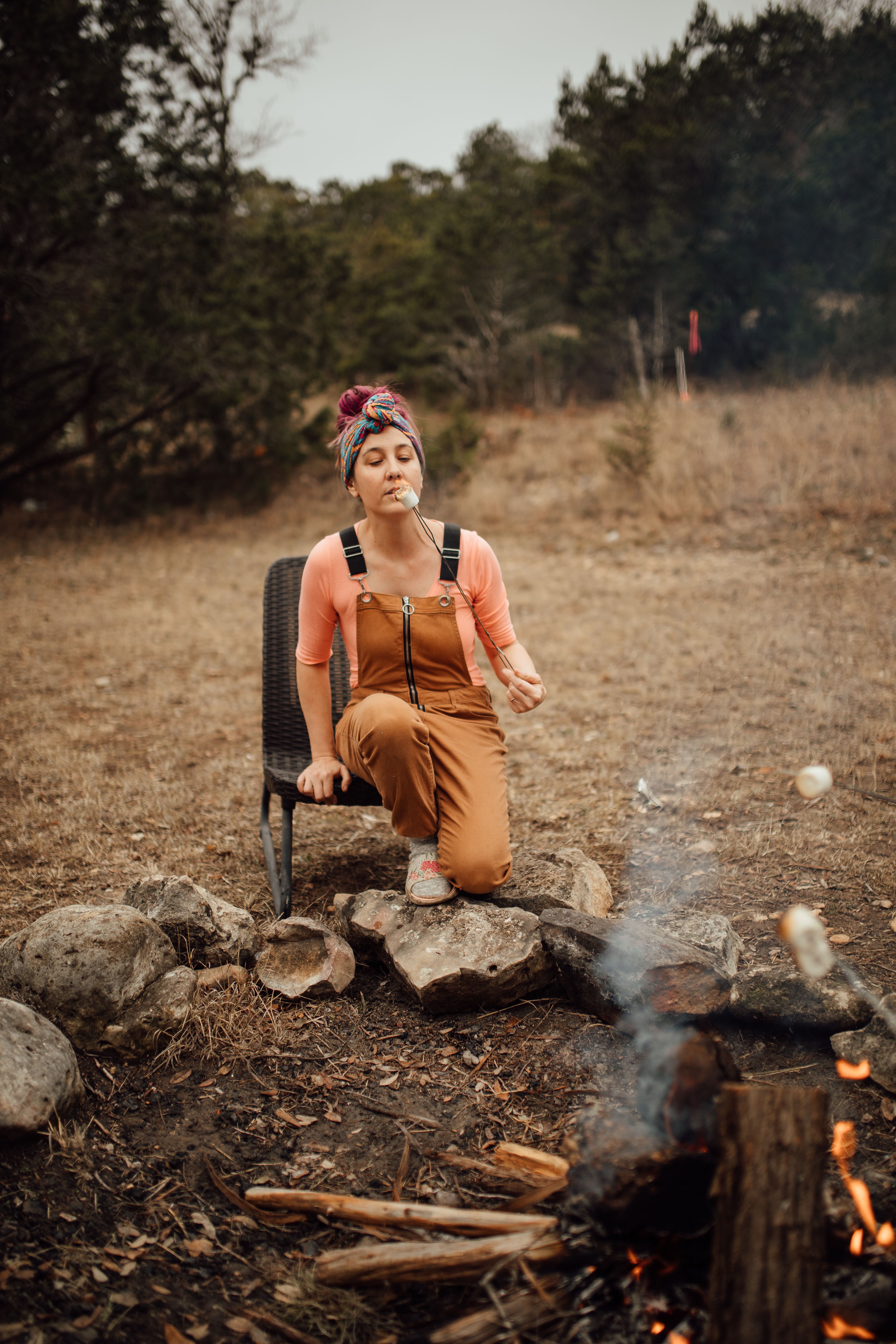 Woman roasting marshmallows at The inn Between in Concan, Texas