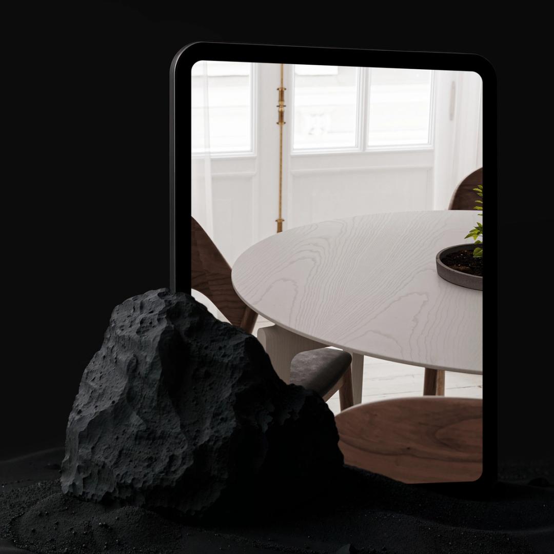 Tablet showing a dining room interior beside a black rock