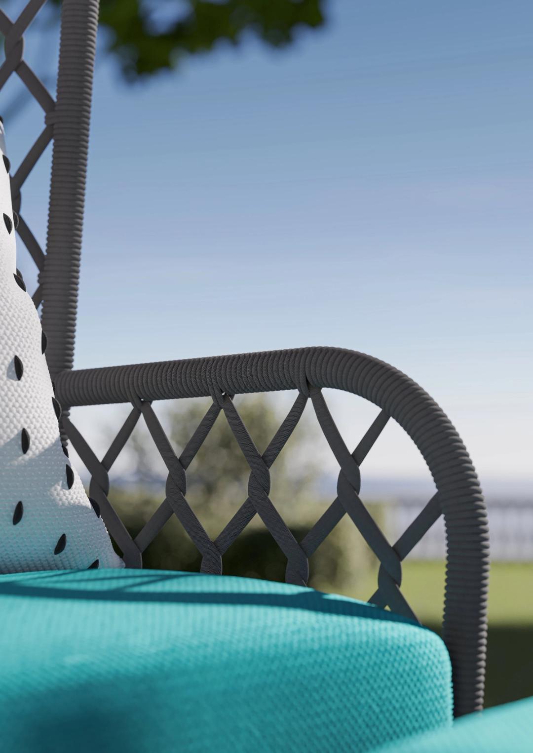 Close view of a woven outdoor armchair with a turquoise cushion