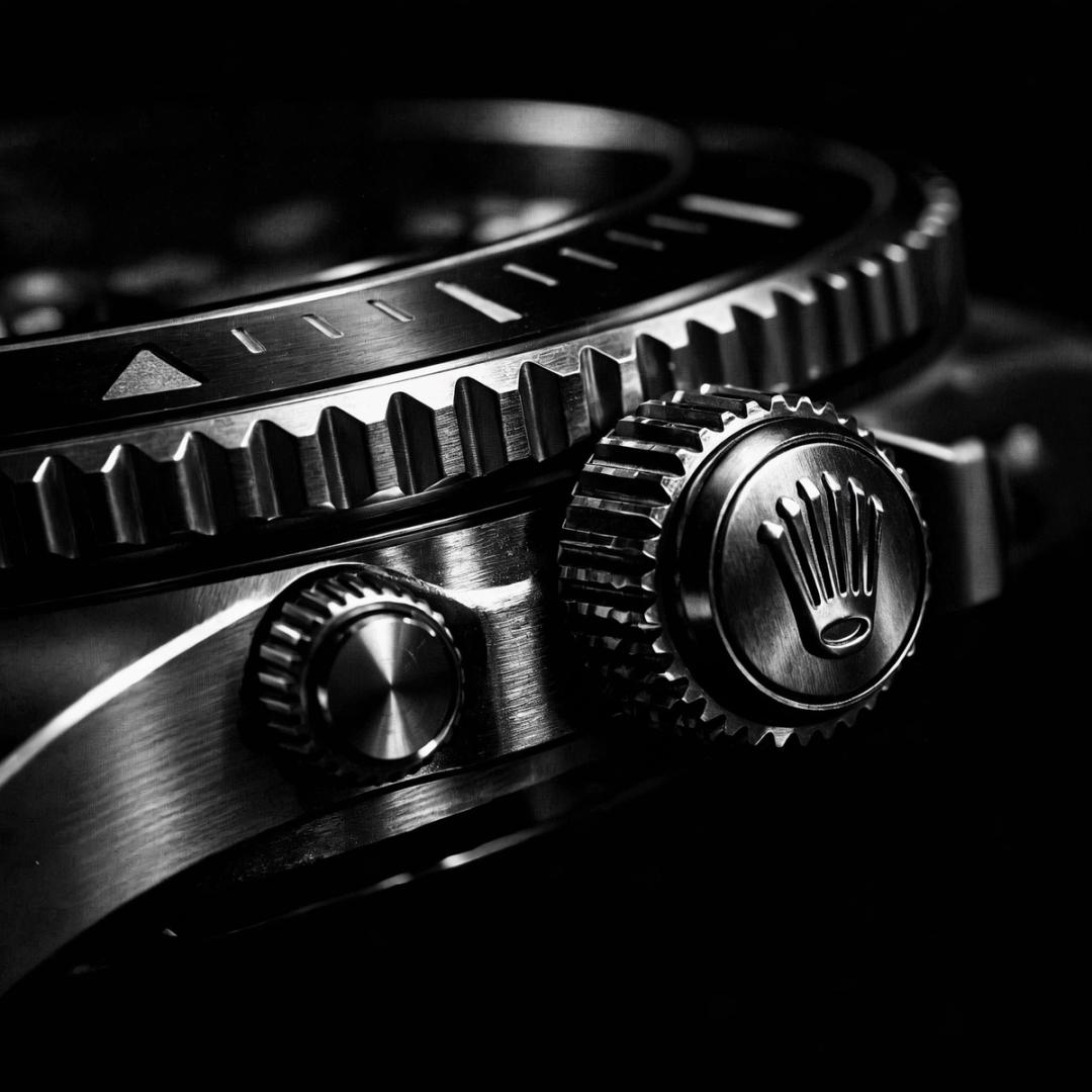 Close view of a steel watch crown and bezel
