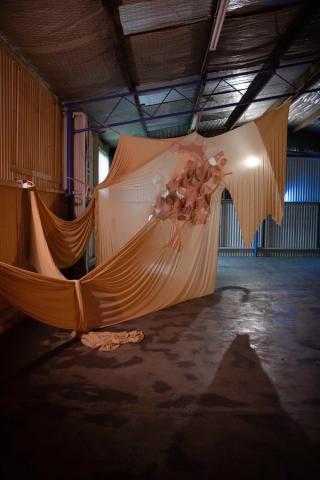 Olly Read, Bodily accretion, 2023, beige jersey fabric, ballet elastic, second-hand brass. Image courtesy of the artist.