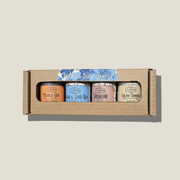Favorites Syrup Samplers box, carboard with window showing 4 x 2oz sample jars of syrup
