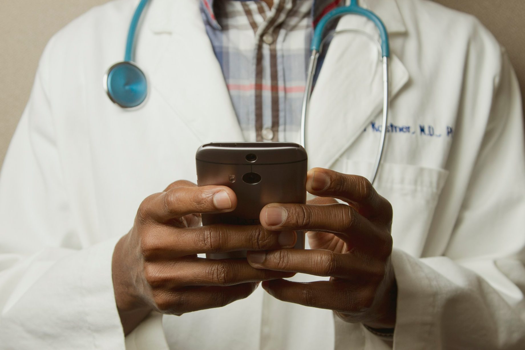 A health worker holding a phone