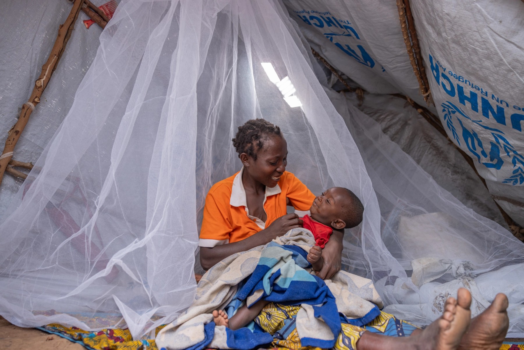 Community member photographed in their local environment during the Malaria No More campaign in Uganda.