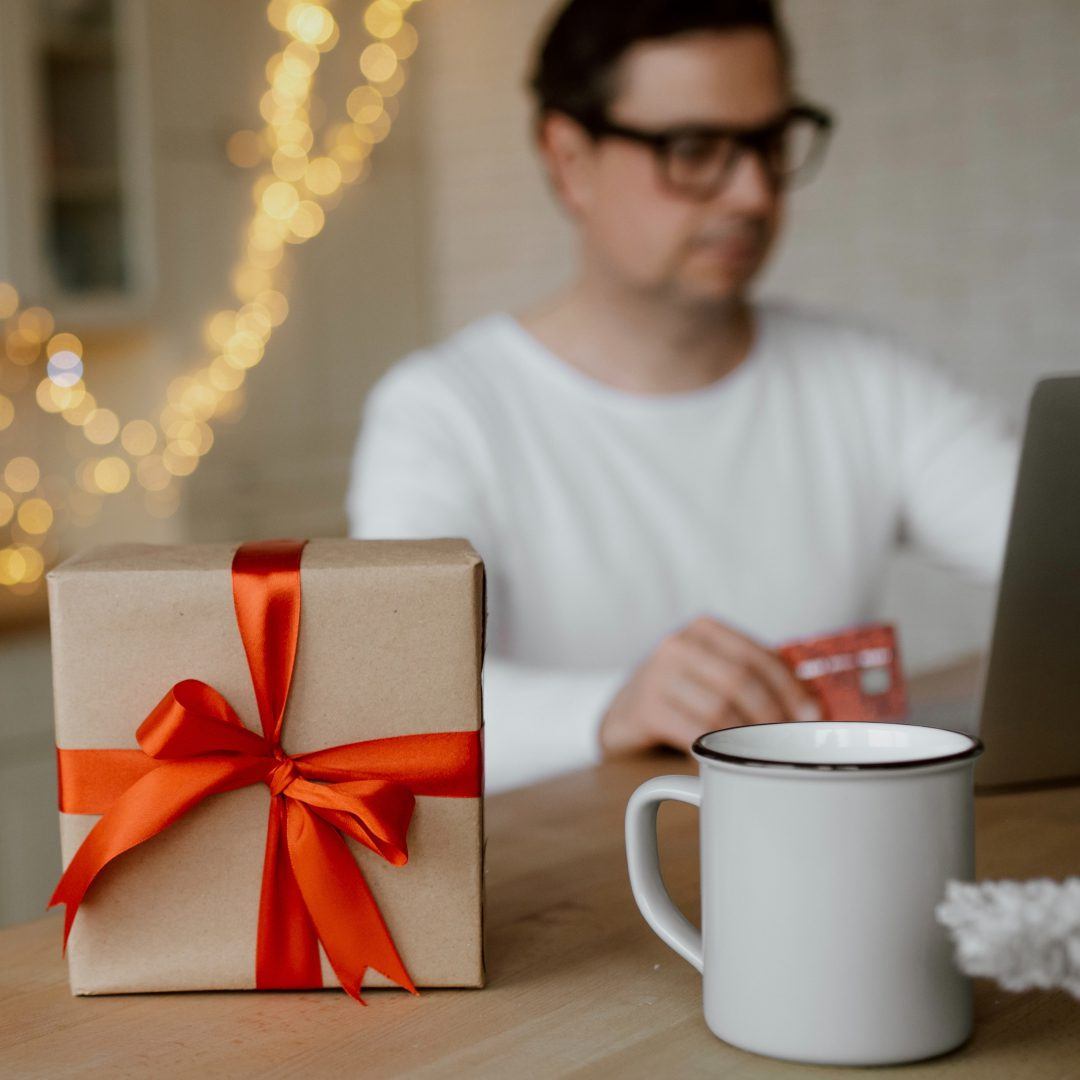 millennial man in kitchen festive christmas atmosphere online shopping on laptop remote work holiday|millennial man in kitchen festive christmas atmosphere online shopping on laptop remote work holiday
