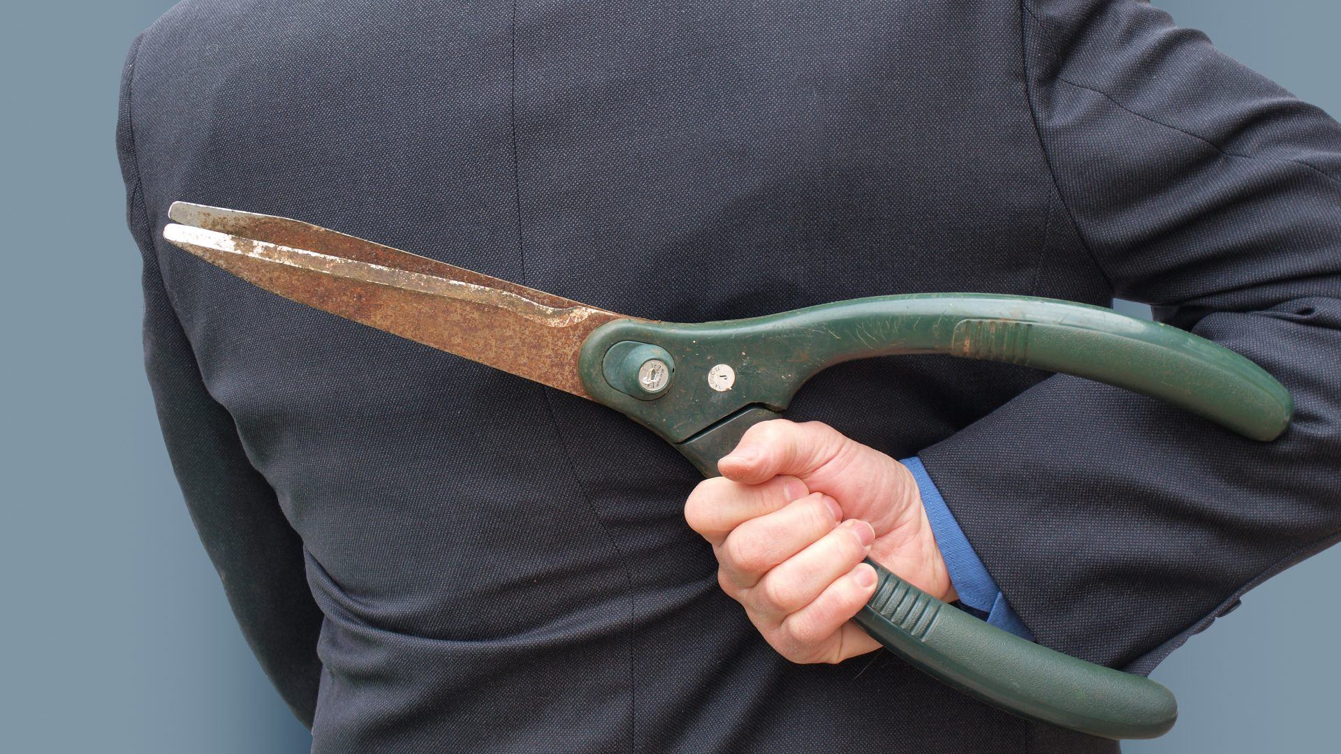 Businessman about to make dirty cuts in business