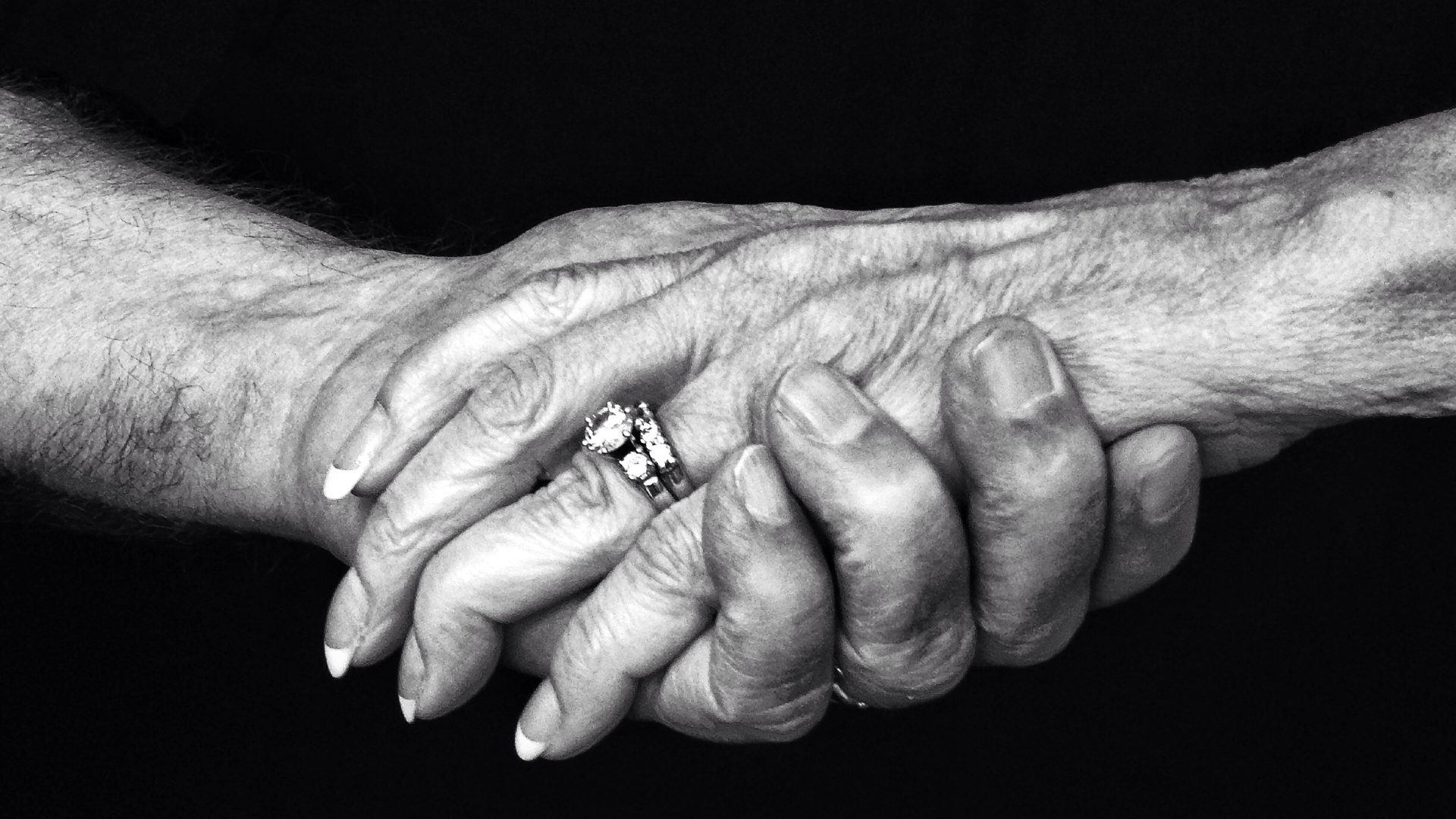 Old couple holding hands, close-up