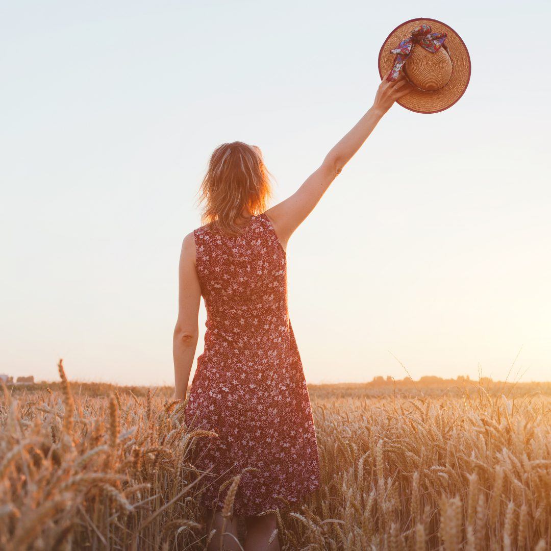 woman waving hand in the field|woman waving hand in the field