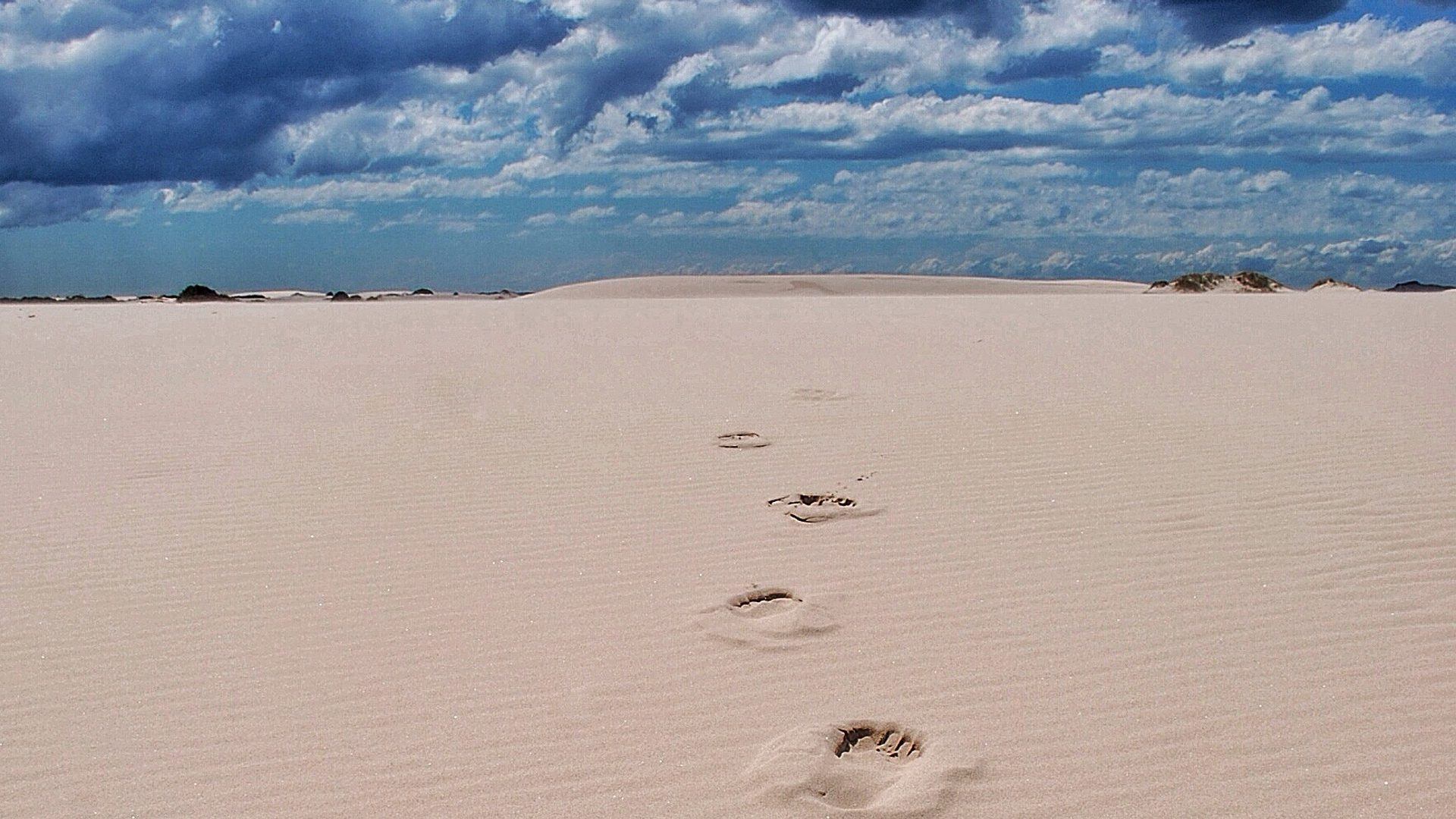 The Barefoot Traveller - footprints on sand