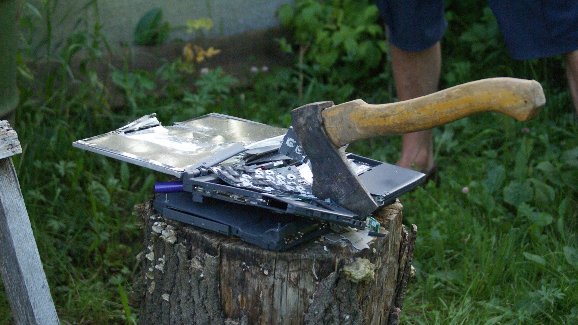 Axe through a broken laptop