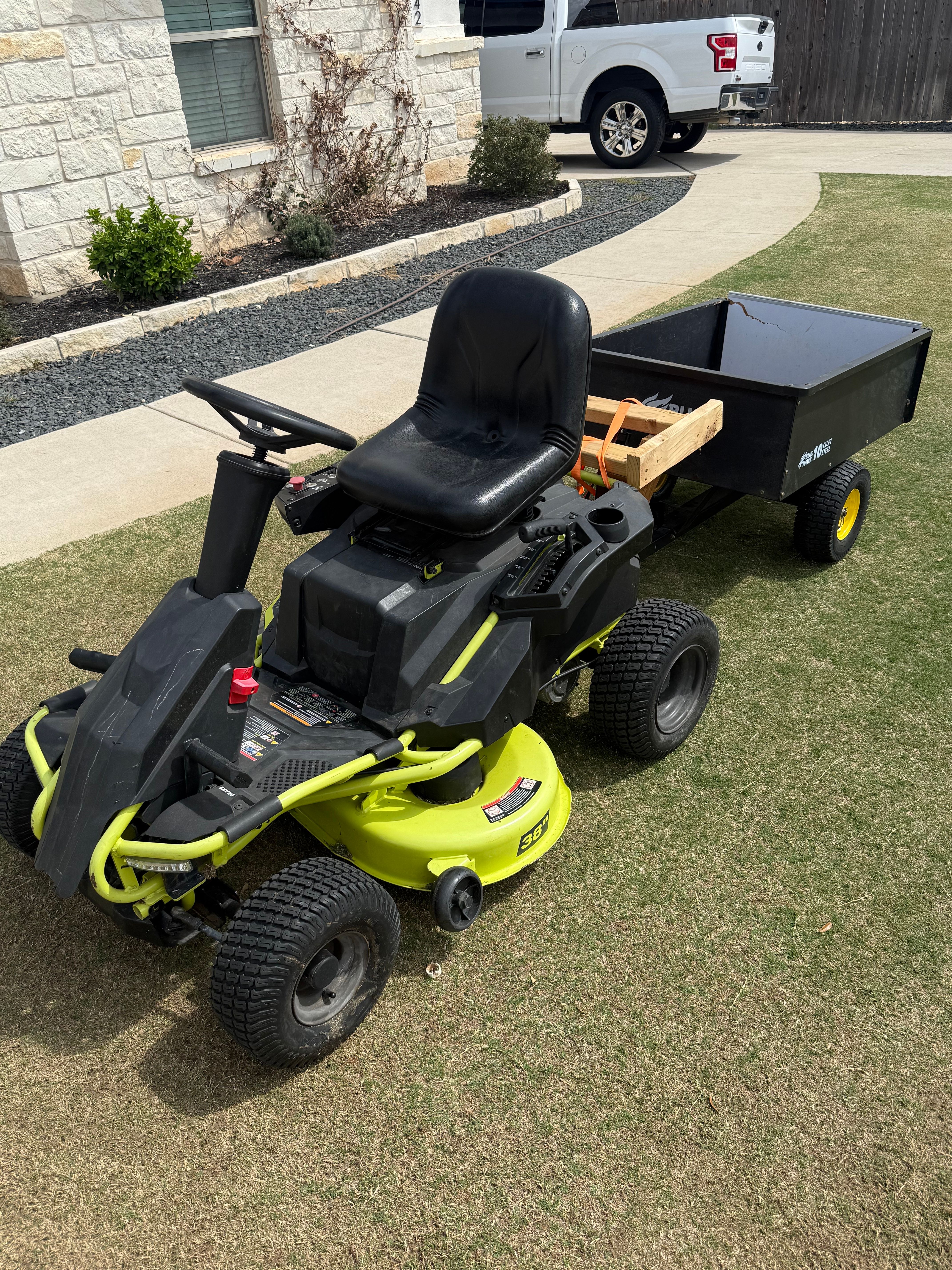 Electric mower pulling trailer