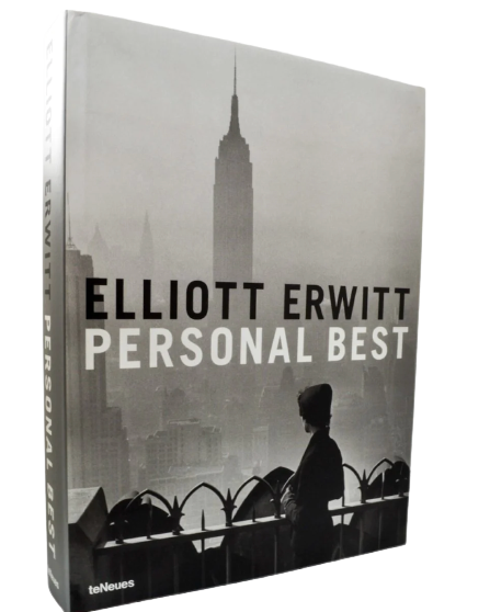 Book cover titled 'Personal Best' by Elliott Erwitt, featuring a black and white photo of a woman on a city balcony with the Empire State Building in the background.